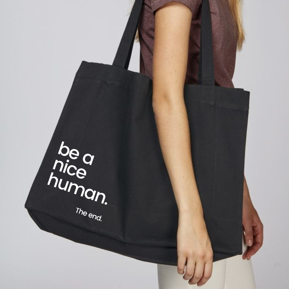 Black tote bag with Be a Nice Human in white writing